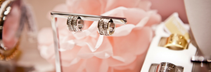 Jewellery Industry Trends 2018 diamond hoop earrings, bracelets and rings on a pale pink rose background